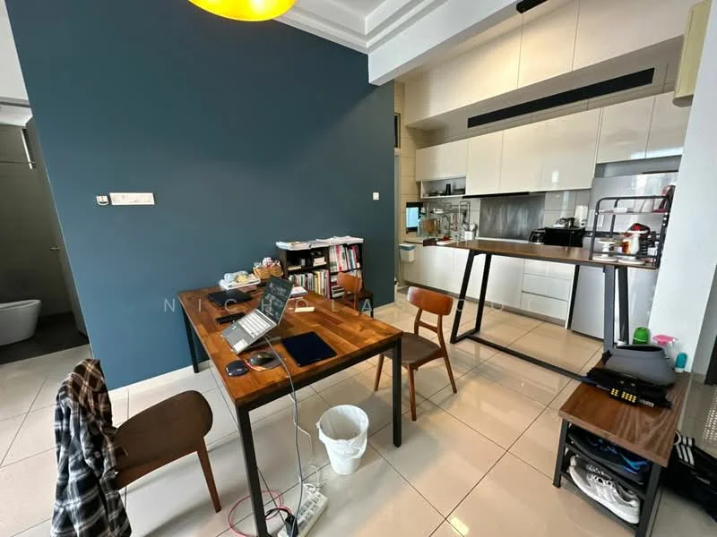 Dining features: dark blue accent wall, white painted walls, rectangular wooden dining table, 4 wooden dining chairs, laptop on table, white waste bin, pendant light fixture, ceramic tile flooring, open kitchen layout, kitchen cabinets with glossy finish, stainless-steel appliances, countertop with bar seating; style: modern. Room features: toilet visible in background.