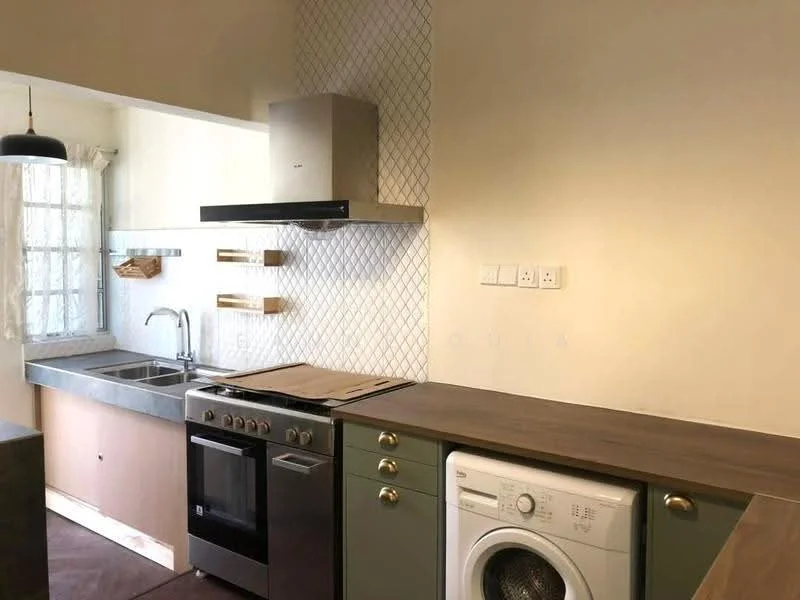 Kitchen features: grey concrete countertop, stainless-steel sink, chrome pull-down faucet, built-in oven, 4-burner gas hob, stainless-steel range hood, white washing machine, green cabinetry with gold handles, white tiled backsplash with geometric pattern, window with sheer curtains, open shelving, dark flooring; style: modern.