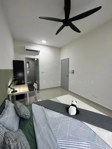Bedroom features: king-size bed with patterned bedding, 5-blade ceiling fan, wall-mounted air conditioning unit, desk with chair, wooden flooring, green accent wall, neutral painted walls, window with natural light, panda plush toy on bed; style: modern.