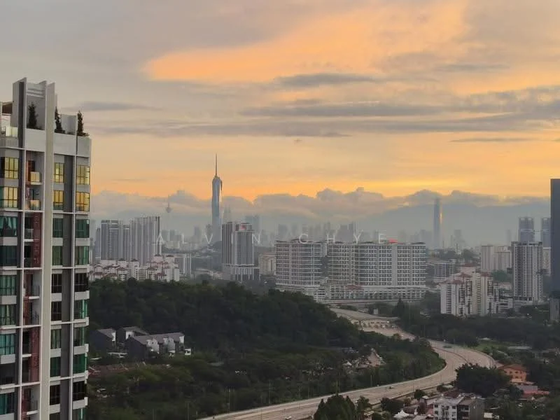 Exterior type: high-rise condominium; features: glass curtain wall, recessed balconies, surrounded by mature greenery, urban skyline view, multiple storey buildings, highway visible in foreground; style: modern.
