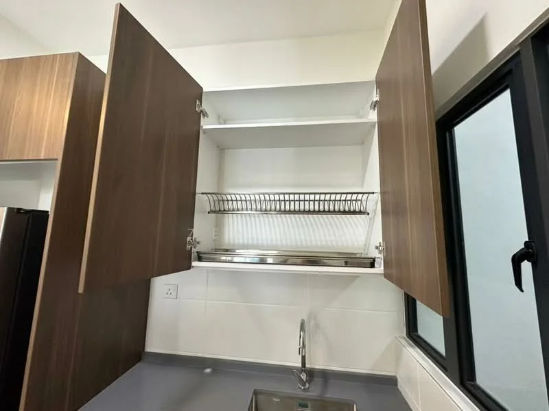 Kitchen features: wood cabinetry, open upper cabinets, metal wire rack, grey countertop, stainless-steel sink, black window, white tiled backsplash, white walls; style: modern.