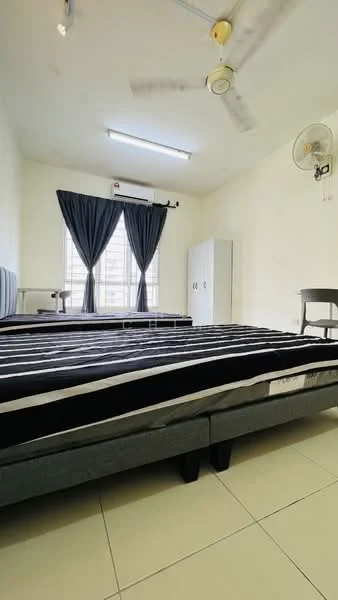 Bedroom features: two single beds with black bed frames, white walls, ceiling fan, window with sheer curtains, built-in wardrobe, tile flooring, desk chair, light fixture on ceiling.