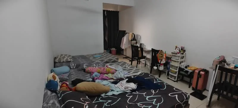 Bedroom features: two double beds with patterned bedding, white painted walls, tile flooring, black curtains, study desk with mirror, plastic storage unit, wooden dining chairs, decorative plush toys, luggage, clothing on beds.