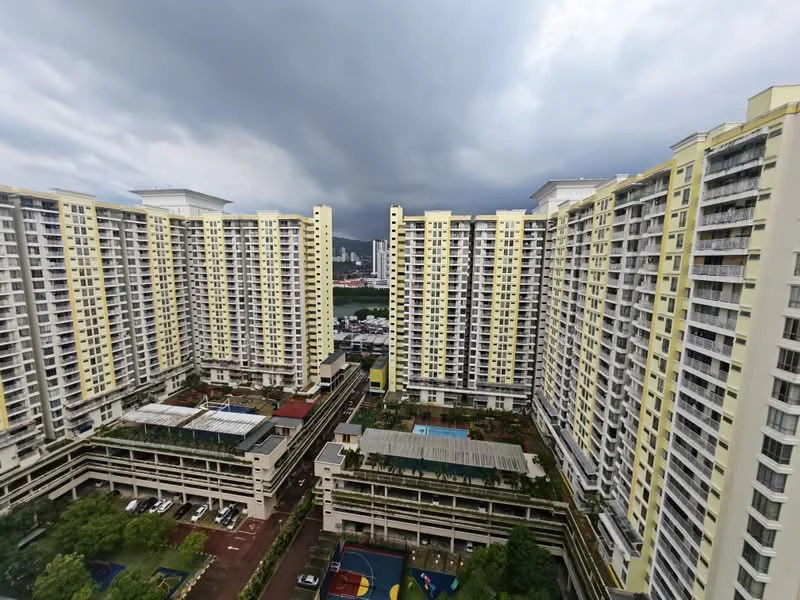 Exterior type: high-rise condominium; features: yellow painted facade, glass curtain wall, multiple storeys, landscaped garden area, swimming pool visible, parking deck, children's playground, surrounded by mature greenery; style: modern.