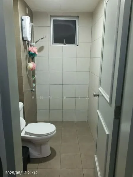 Bathroom features: white tiled walls, beige tiled flooring, one-piece toilet, small window, shower with wall-mounted faucet, water heater, toilet paper holder, decorative plant on wall.