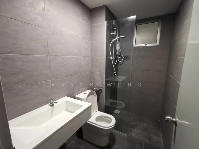 Bathroom features: grey tile cladding on walls, dark grey tile flooring, single-sink vanity with integrated basin, chrome basin mixer faucet, one-piece toilet, walk-in shower with glass enclosure, handheld shower, shower wall with grey tiles, small window for natural light; style: modern.