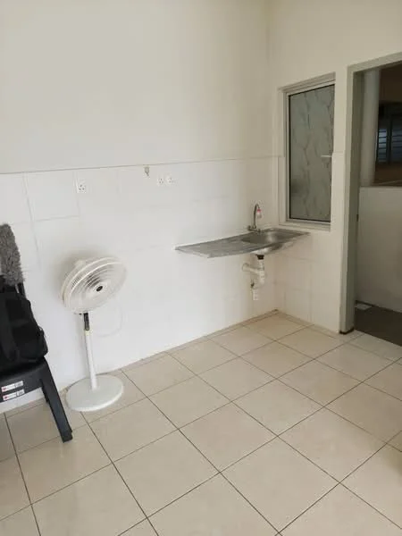 Room features: white painted walls, cream tiled flooring, stainless-steel sink, wall-mounted faucet, window with frosted glass, ceiling fan on stand, countertop with metal surface, no visible appliances.