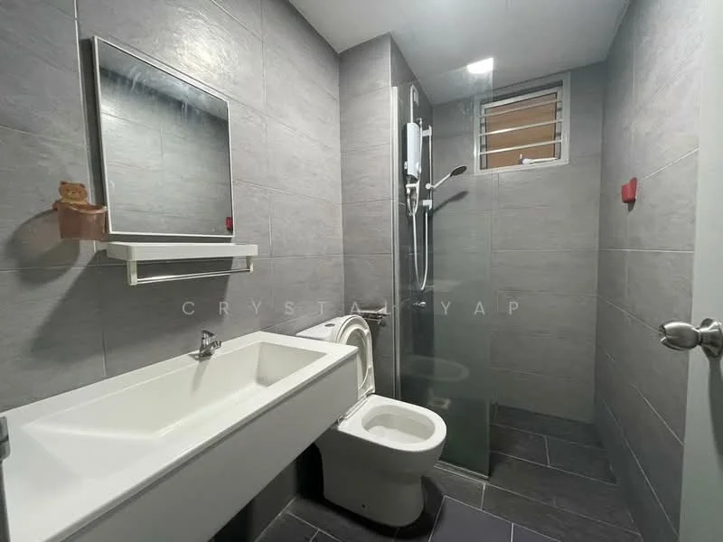 Bathroom features: grey tiled walls, dark grey tiled flooring, single-sink vanity with white cabinet, chrome basin mixer faucet, framed mirror, walk-in shower with glass enclosure, rain shower head, toilet, window for natural light, wall-mounted shelf; style: modern.