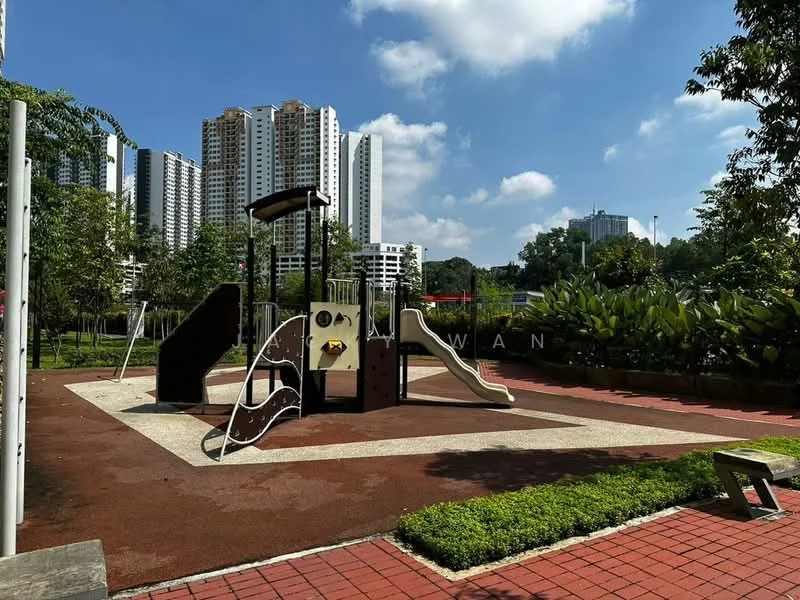 Exterior type: landscape garden; features: children's playground with slides, play structures, rubberized flooring, manicured lawn, surrounding greenery, paved walkway, urban backdrop with high-rise buildings, open sky; style: modern.