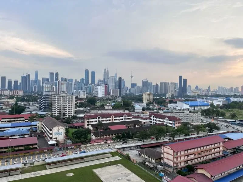 Exterior type: high-rise condominium; features: city skyline view, urban landscape, mixed-use buildings, commercial structures, residential buildings, green spaces, roadway visible, parking lots, varied architectural styles; style: modern.