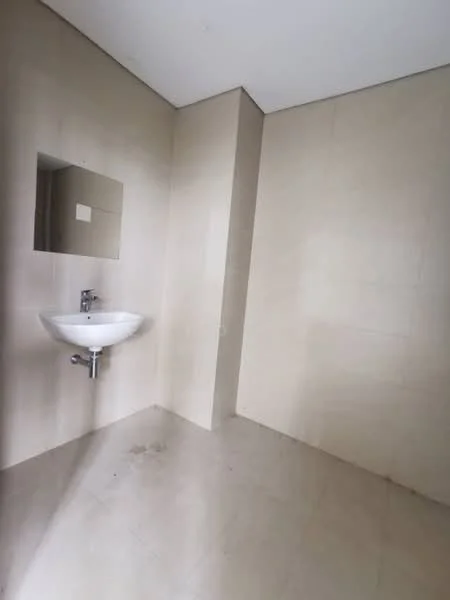 Bathroom features: wall-mounted sink, mirror above sink, beige tiled walls, beige tiled flooring, no visible toilet, no visible shower or bathtub, minimalist design, natural light from window; style: modern.