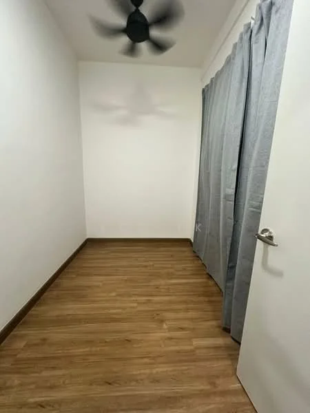 Room features: white painted walls, wooden flooring, 5-blade ceiling fan, grey curtains, white door.