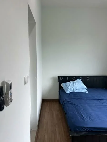 Bedroom features: wooden flooring, white painted walls, single bed with blue bedding, bedside wall with intercom, window with no visible treatment, minimalist decor; style: modern.
