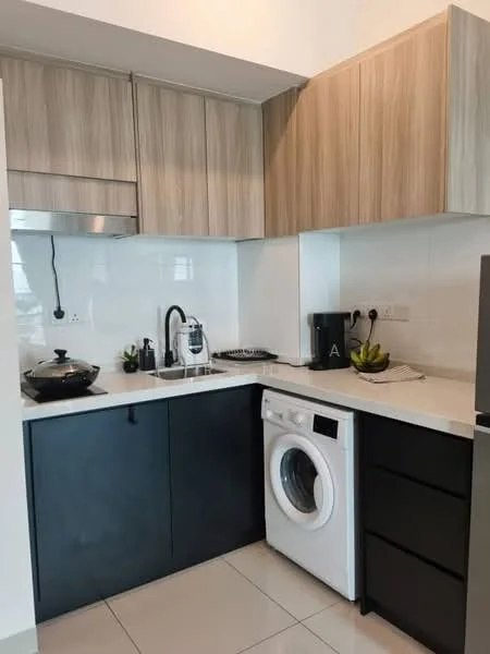 Kitchen features: wood cabinetry in light brown, black lower cabinetry, white countertop, stainless-steel sink, chrome pull-down faucet, built-in gas hob, exhaust hood, front-load washing machine, black coffee maker, black countertop appliances, ceramic tile flooring, wall-mounted electrical outlets, decorative bowl with fruit; style: modern.