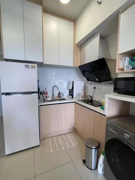 Kitchen features: white upper cabinets, light wood lower cabinets, black countertop, stainless-steel single-bowl sink, chrome pull-down faucet, built-in microwave, freestanding refrigerator, washing machine, tile flooring, wall-mounted range hood, kitchen towel, trash bin, cleaning supplies; style: modern.