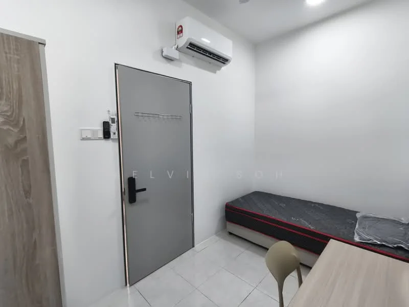 Room features: white painted walls, tile flooring, 1 wall-mounted split AC, single bed frame without mattress, wooden door, grey door with handle, small dining table, plastic chair; style: minimalist.
