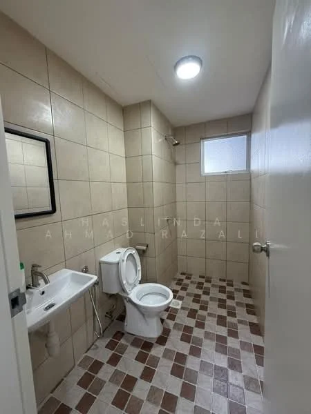 Bathroom features: cream tiled walls, brown and cream checkered tile flooring, single-sink wall-mounted basin, one-piece toilet, shower with wall-mounted faucet, mirror above sink, window for natural light, ceiling light fixture; style: modern.