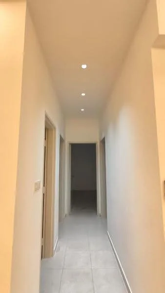 Hallway features: white painted walls, recessed downlights, tile flooring, doorways leading to other rooms; style: modern.