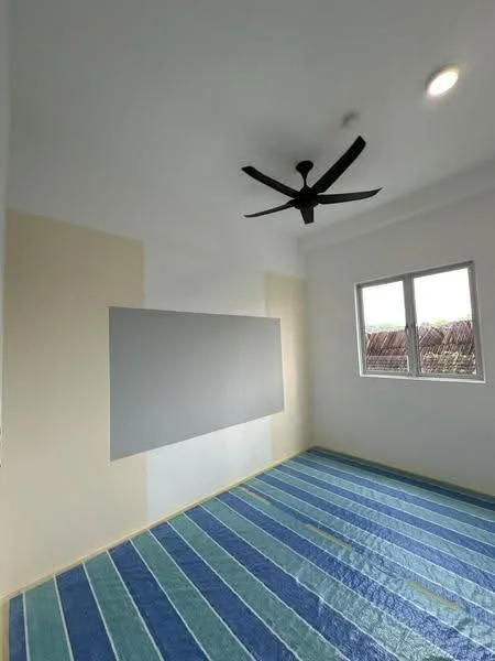 Room features: white painted walls, beige accent wall, striped blue and green carpet, 5-blade ceiling fan with light, floor-to-ceiling window, natural light from window; style: modern.
