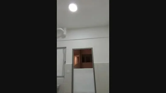 Room features: white painted walls, grey tiled walls, recessed ceiling light, window, doorway.