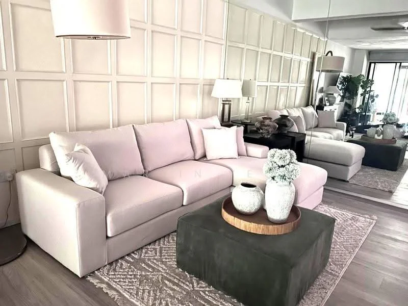 Living features: light beige fabric sofa, decorative cushions, green ottoman with wooden tray, area rug with geometric pattern, glass coffee table, two table lamps with white shades, mirrored wall, wooden side table, decorative vases with flowers; style: modern.