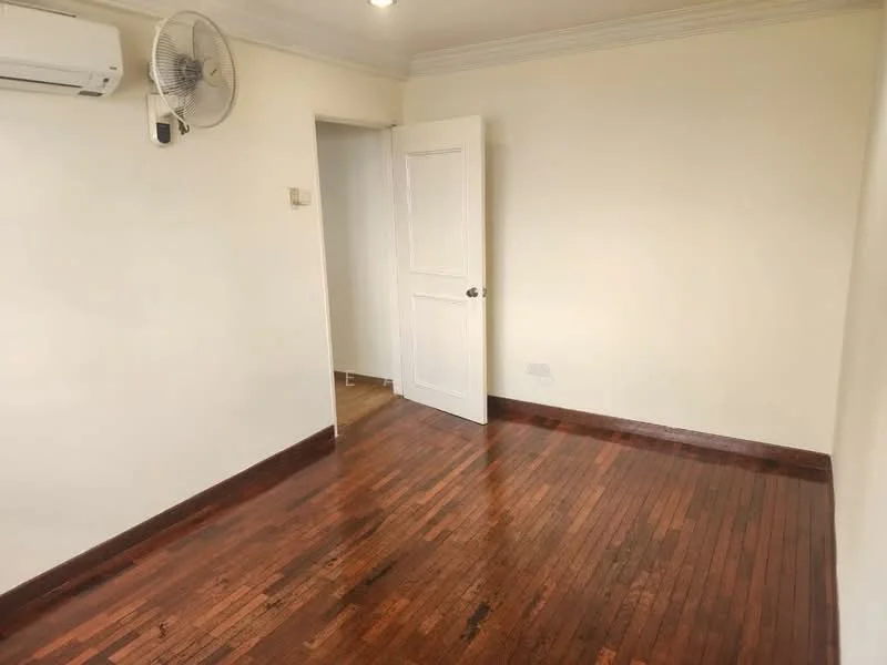 Room features: wooden flooring, white painted walls, ceiling fan, wall-mounted split AC, door with handle, crown moulding.