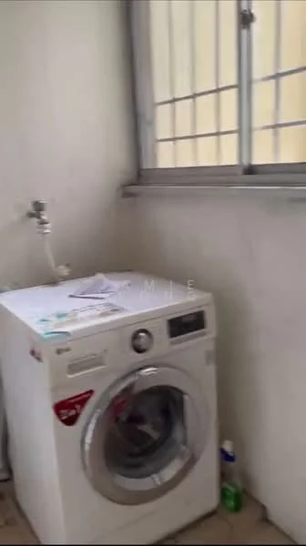 Laundry features: front-load washing machine, window with metal bars, light-colored walls, tile flooring, shelf with miscellaneous items, cleaning supplies on the floor.
