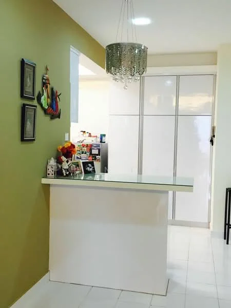 Room features: green painted walls, white tiled flooring, chandelier with crystals, white cabinetry, decorative wall art, decorative figurines, flower arrangement, open space layout; style: modern.