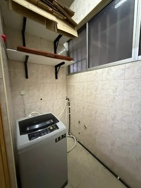 Laundry features: top-load washing machine, wall-mounted shelves, grey tiled flooring, light beige wall tiles, window with grid pattern, plumbing connections visible, exposed pipes, neutral color scheme.