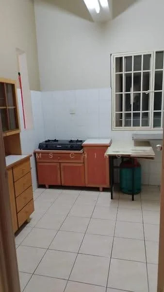 Kitchen features: white tiled walls, cream tiled flooring, wooden cabinetry in light brown, countertop with laminate finish, gas stove with two burners, kitchen sink, window with security bars, open shelving, green gas cylinder, wall-mounted light fixture.