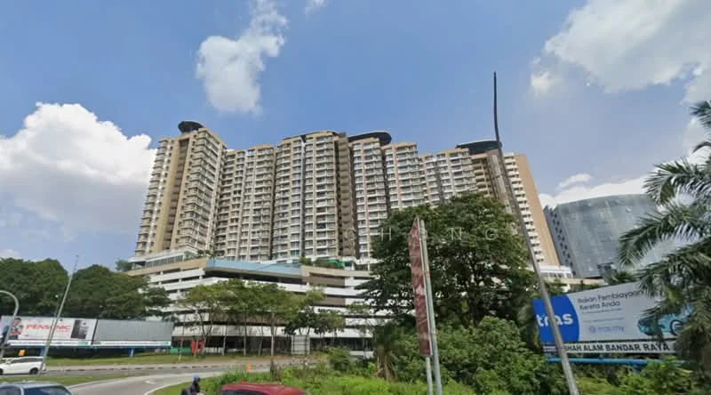 Exterior type: high-rise condominium; features: glass curtain wall, cream painted facade, recessed balconies, multiple storeys, surrounded by greenery, urban context with main road, signage visible, parking area at the base; style: modern.