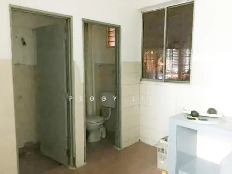 Room features: white tiled walls, grey tiled flooring, window with metal frame, toilet, sink, light fixture, doorway, corner space.