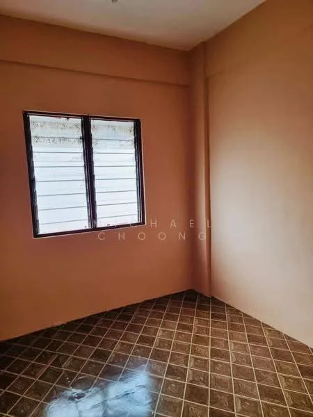 Room features: orange painted walls, brown tiled flooring, single window, grid pattern on window, corner room.