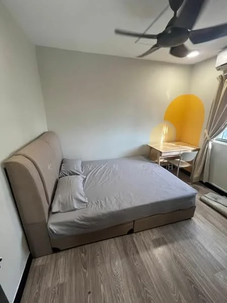 Bedroom features: queen-size bed with upholstered headboard, light grey bedding, wooden flooring, 5-blade ceiling fan, window with sheer curtains, small study table, chair, yellow accent wall, decorative wall light, area rug; style: modern.
