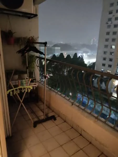 Room features: balcony with railing, tile flooring, clothes drying rack, potted plants, outdoor view, clothes hanger, night lighting; view: city.