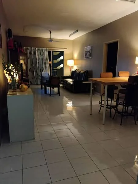 Living features: white tiled flooring, cream painted walls, 5-blade ceiling fan, sofa set in black leather, coffee table, floor-to-ceiling sliding glass door, curtains with geometric pattern, table with four chairs, decorative plants, wall-mounted artwork; style: modern.