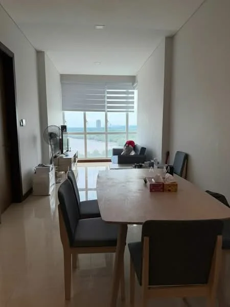 Dining features: dining table with light wood finish, 4 upholstered dining chairs in grey, large window with sheer roller blinds, floor-to-ceiling window, white painted walls, polished tile flooring, ceiling lights, fan, view of city skyline; style: modern; view: city. Living features: sofa in dark color, coffee table, decorative items on table, floor-to-ceiling window, view of city skyline; style: modern; view: city.