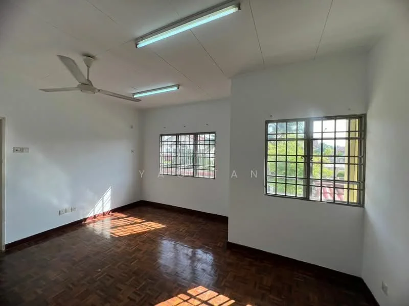 Room features: white painted walls, ceiling fan, parquet wood flooring, two windows with metal grilles, natural light from windows, light fixtures on ceiling.
