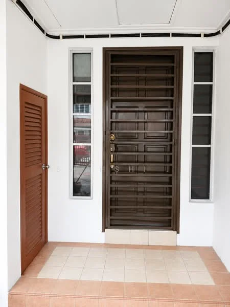 Exterior features: main entrance door with security grille, brown wooden door, two vertical windows on either side of the door, cream tiled flooring, brown louvered door on the left, white painted walls, overhead ceiling with light fixture, small step leading to the entrance; style: modern.
