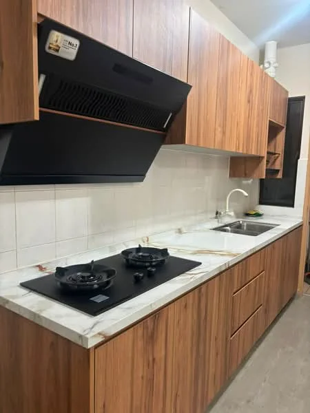 Kitchen features: wood cabinetry, marble countertop, double-bowl stainless-steel sink, chrome pull-down faucet, built-in gas hob, exhaust hood, white tiled backsplash, grey flooring; style: modern.
