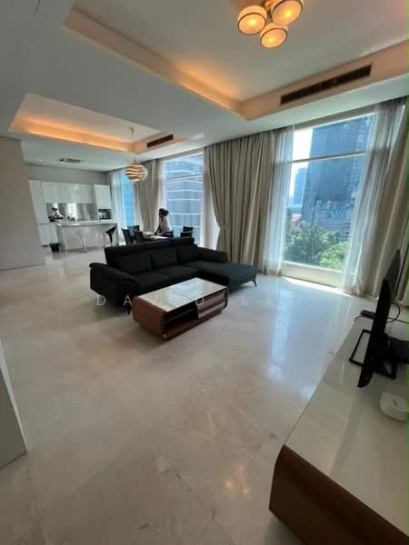 Living features: large floor-to-ceiling windows, grey fabric sectional sofa, coffee table with wooden base, TV console with wooden finish, marble flooring, recessed downlights, modern pendant light, curtains, open layout to kitchen, view of city skyline; style: modern; view: city.