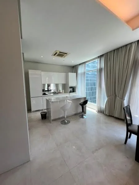 Kitchen features: white cabinetry, marble countertop, stainless-steel appliances, single-bowl stainless-steel sink, chrome pull-down faucet, 4-burner gas hob, built-in oven, bar stools, pendant lighting, floor-to-ceiling windows, light grey tile flooring, sheer curtains, recessed downlights, open layout; style: modern; view: city.