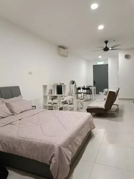 Bedroom features: queen-size bed with light grey bedding, upholstered headboard, white painted walls, tile flooring, 5-blade ceiling fan, wall-mounted split AC, small dining table with chairs, sofa bed, decorative plant on table, open shelving unit; style: modern.