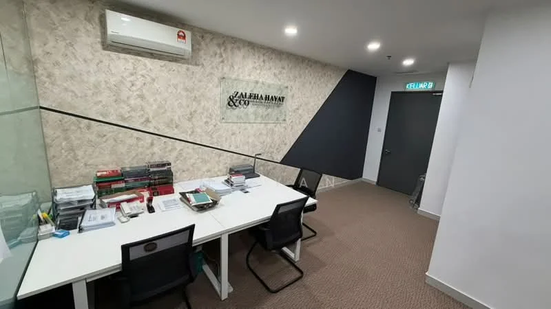 Study features: carpeted flooring, white painted walls, glass partition, modern desk with multiple workstations, black office chairs, shelves with books, air conditioning unit, LED ceiling lights; style: modern.