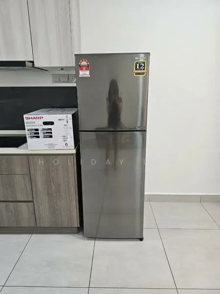 Kitchen features: stainless-steel fridge, built-in cabinetry with wood finish, ceramic tile flooring, black countertop, wall-mounted cabinets, appliance box with microwave, neutral wall color, under-cabinet lighting; style: modern.