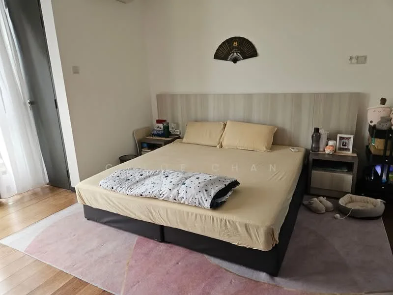 Bedroom features: queen-size bed with beige bedding, wooden headboard, nightstand with lamp, framed artwork on wall, light-colored walls, wooden flooring, area rug with geometric pattern, sliding door to balcony, decorative fan on wall, soft slippers on floor, stuffed animal on nightstand; style: modern.