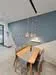 Dining features: wooden dining table, 4 wooden dining chairs, pendant lighting, grey accent wall, white walls, tile flooring, recessed ceiling lights; style: modern.