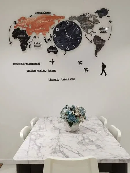 Dining features: marble dining table, white dining chairs, decorative wall clock, world map wall art, decorative flowers in vase, text on wall; style: modern.