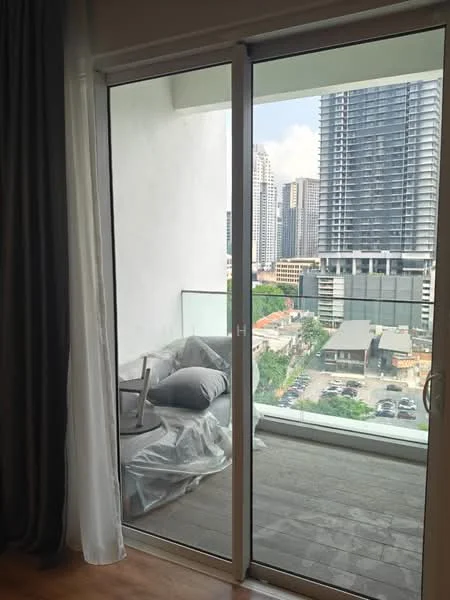 Room features: floor-to-ceiling sliding glass door, grey curtains, wooden flooring, outdoor balcony furniture covered in plastic, city skyline view; style: modern; view: city.