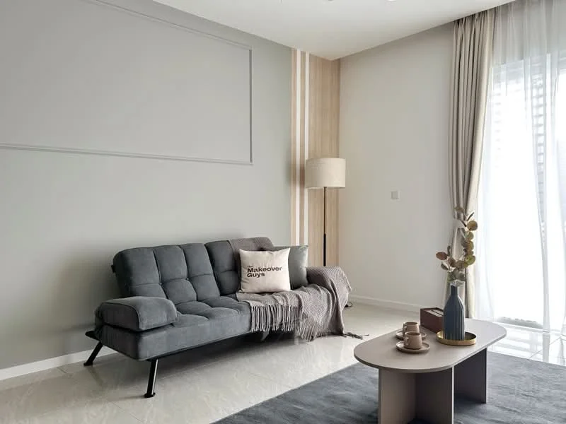 Living features: grey fabric sofa, throw blanket on sofa, decorative pillow with text, round coffee table, vase with decorative plant, light-colored flooring, floor-to-ceiling windows with sheer curtains, wall-mounted lamp, accent wall with wood paneling, neutral wall color; style: modern.